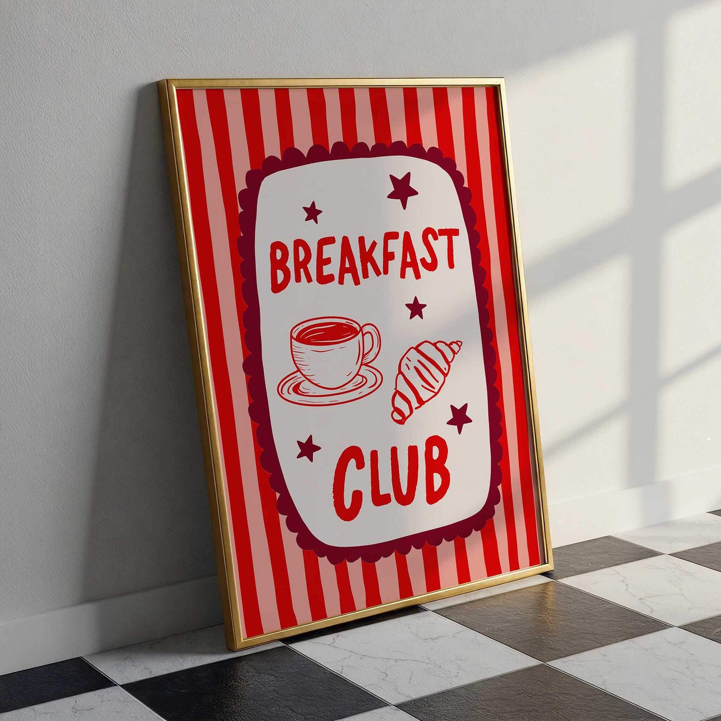 A framed poster with a red and white striped background, featuring the text "BREAKFAST CLUB" and illustrations of a cup of coffee and a croissant.