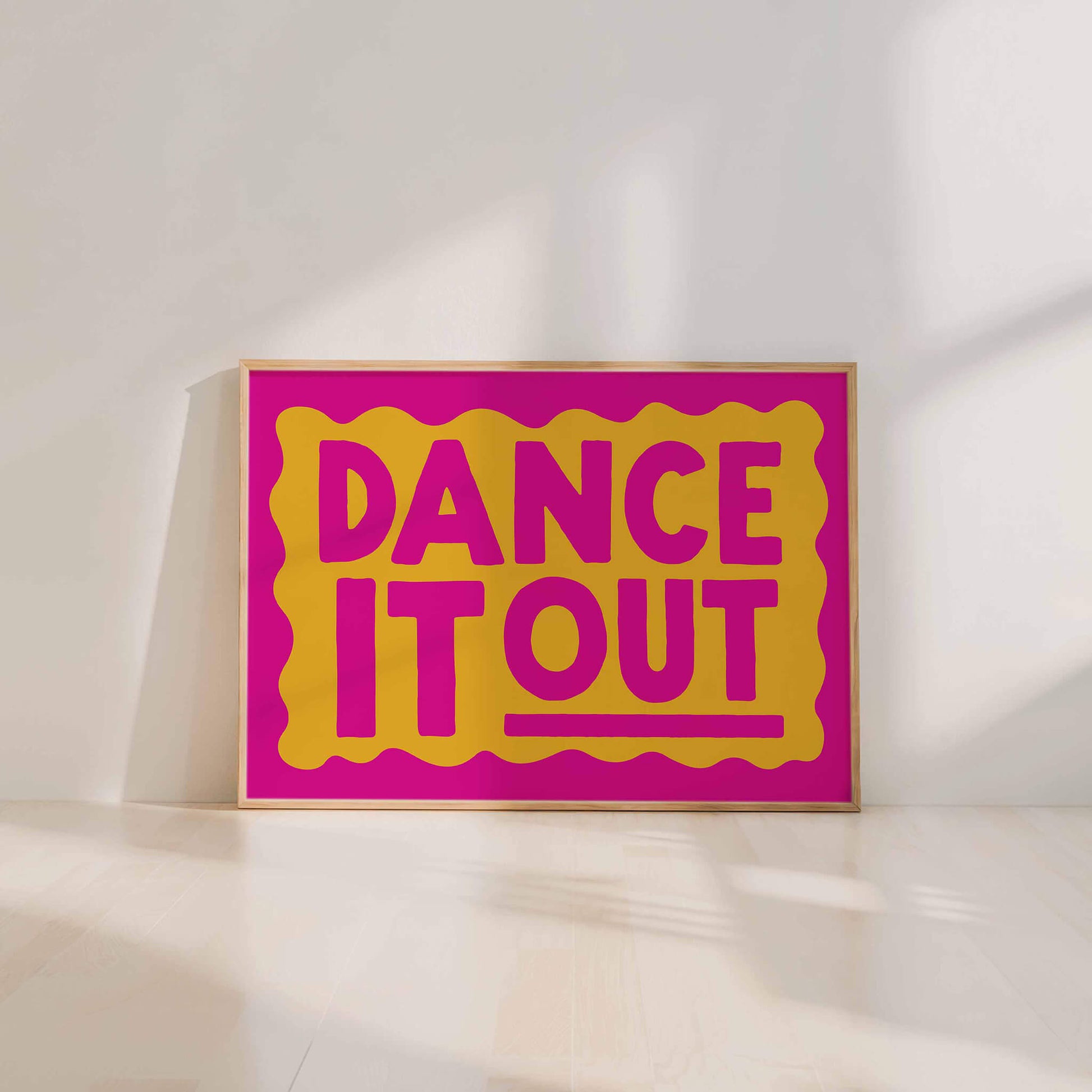 A large poster with the text "DANCE IT OUT" in bold, yellow and pink letters.