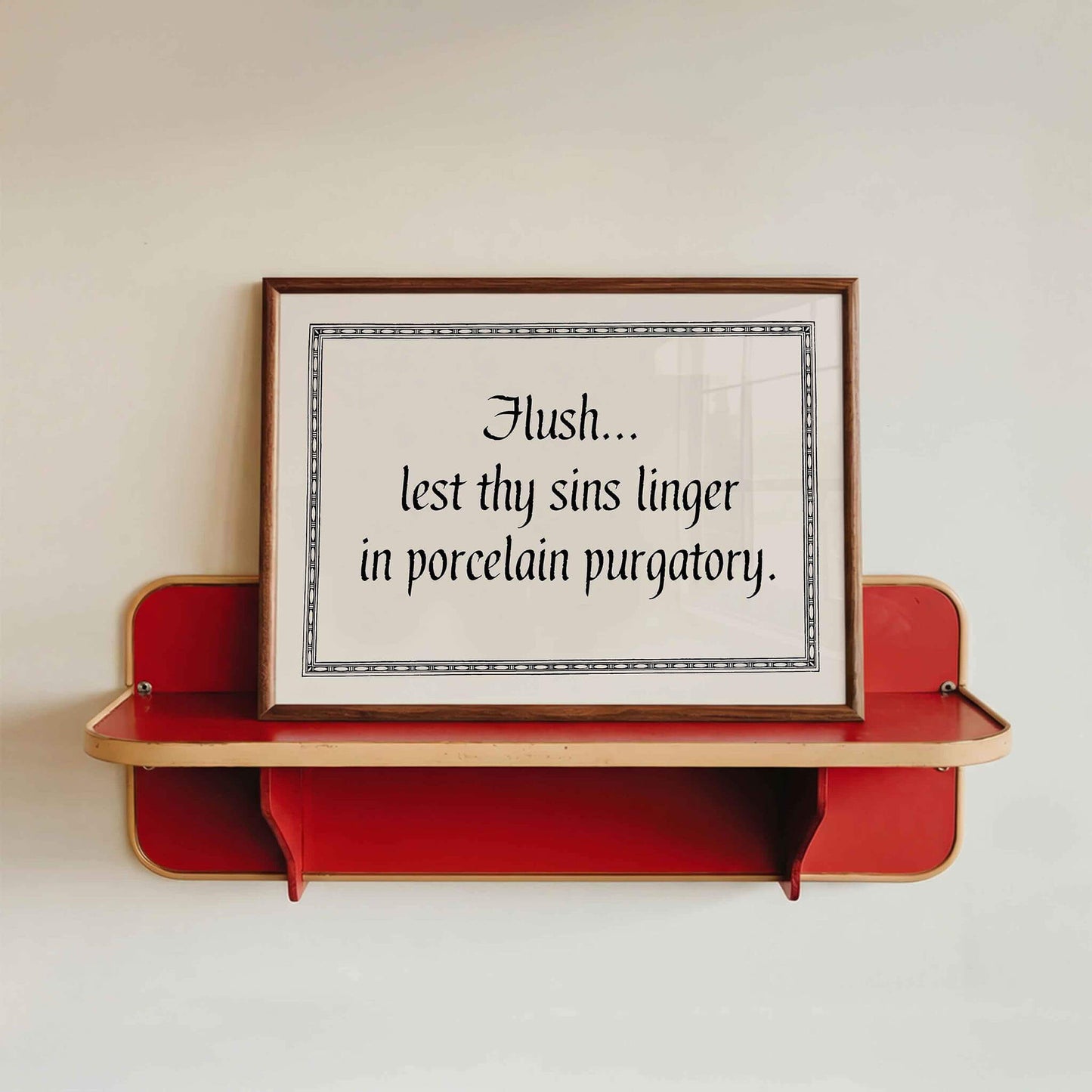 a red shelf with a framed quote on it.