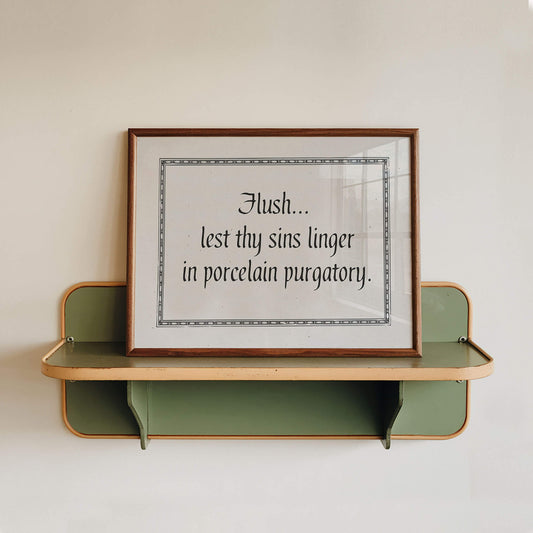 a framed quote on a shelf against a white wall.