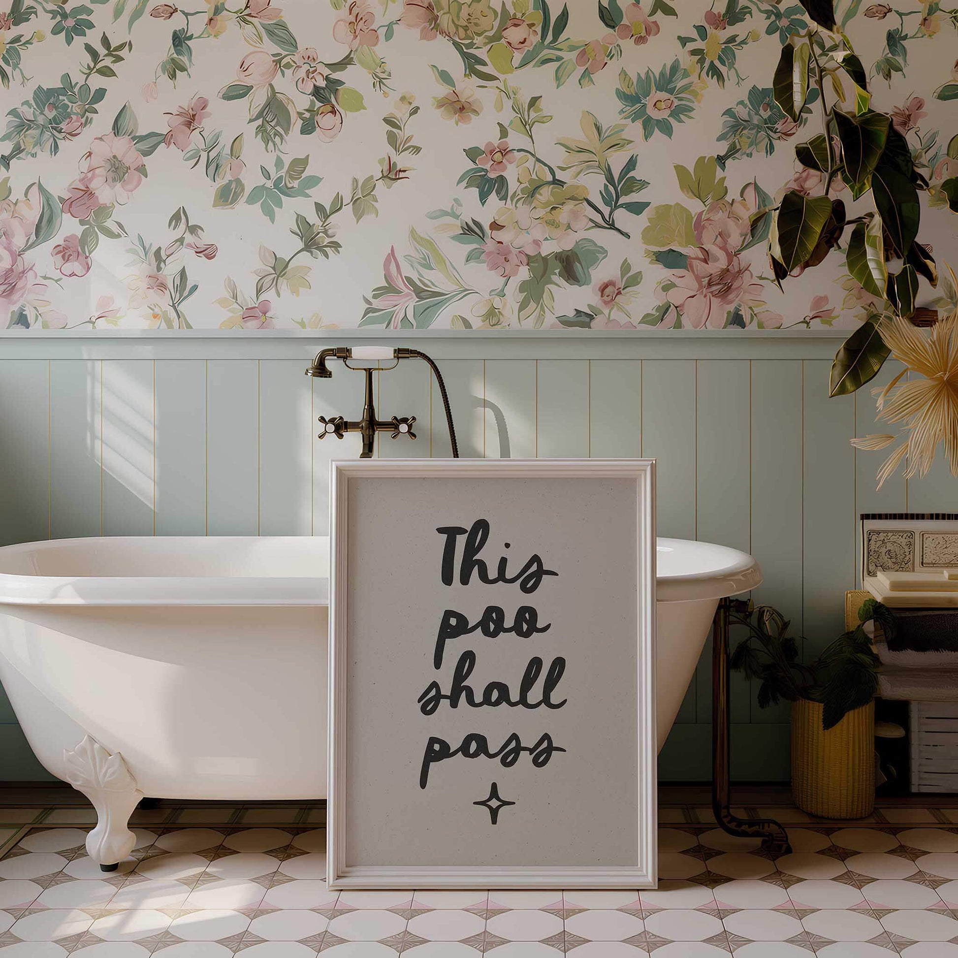 a bathroom with a white clawfoot bathtub, a framed sign with the text "This poo shall pass", and a floral wallpaper.
