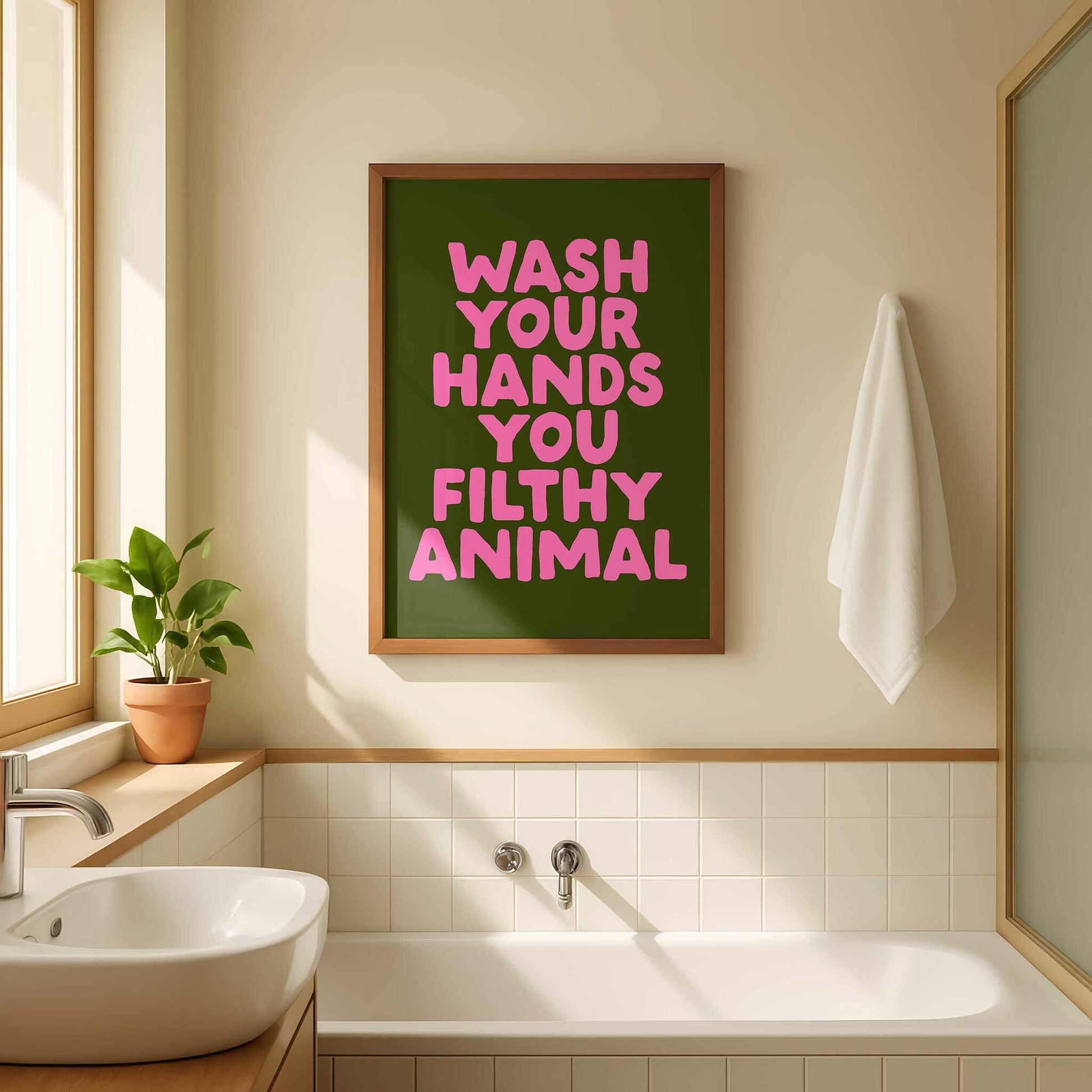 a bathroom with a framed poster on the wall that reads "WASH YOUR HANDS YOU FILthy ANIMAL".