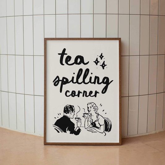 A framed poster with the text "tea spilling corner" and an illustration of a man and woman sitting at a table, enjoying tea together.