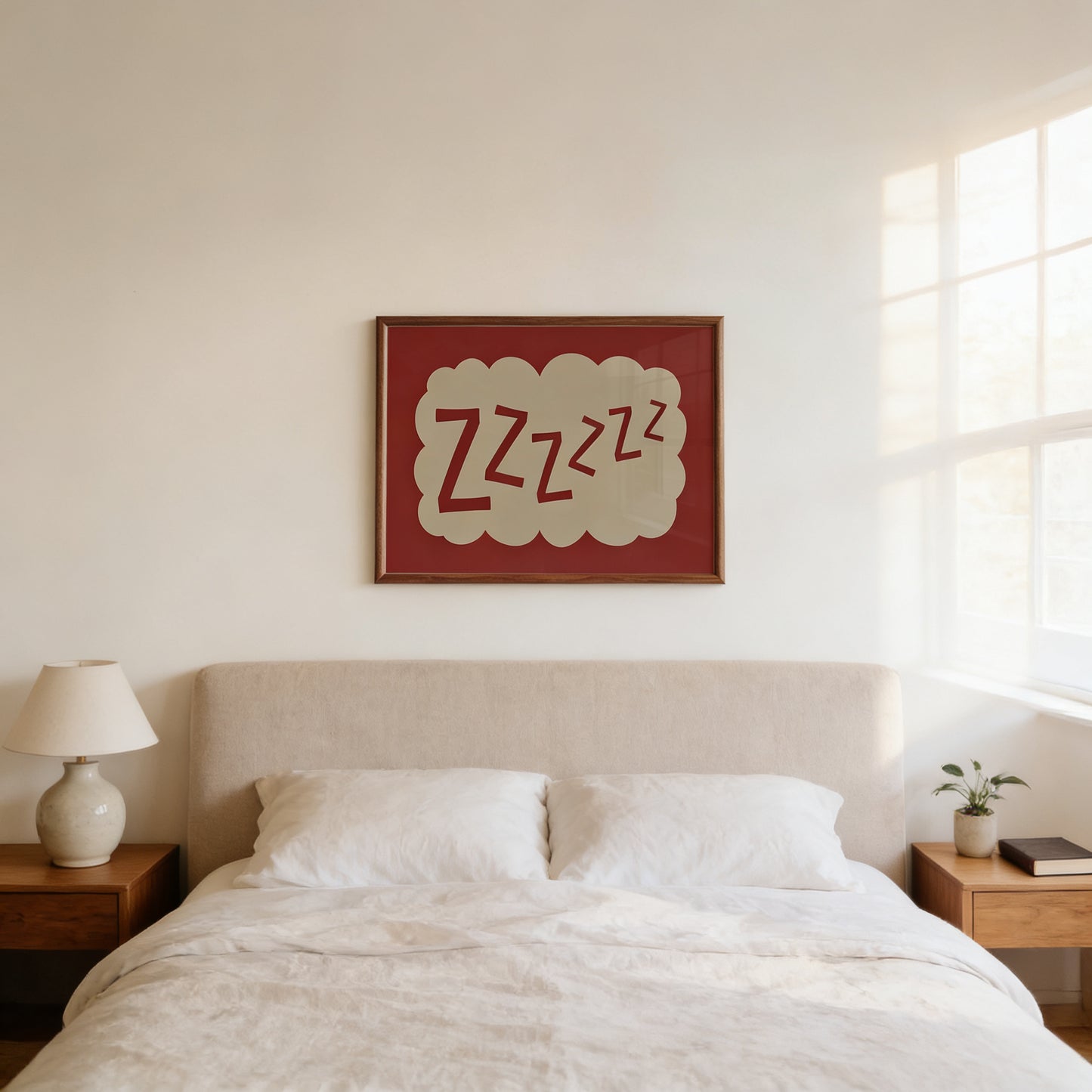 a bedroom with a bed, a nightstand, and a lamp. Above the bed, there is a framed picture with the text "zzzzzz" written on it.