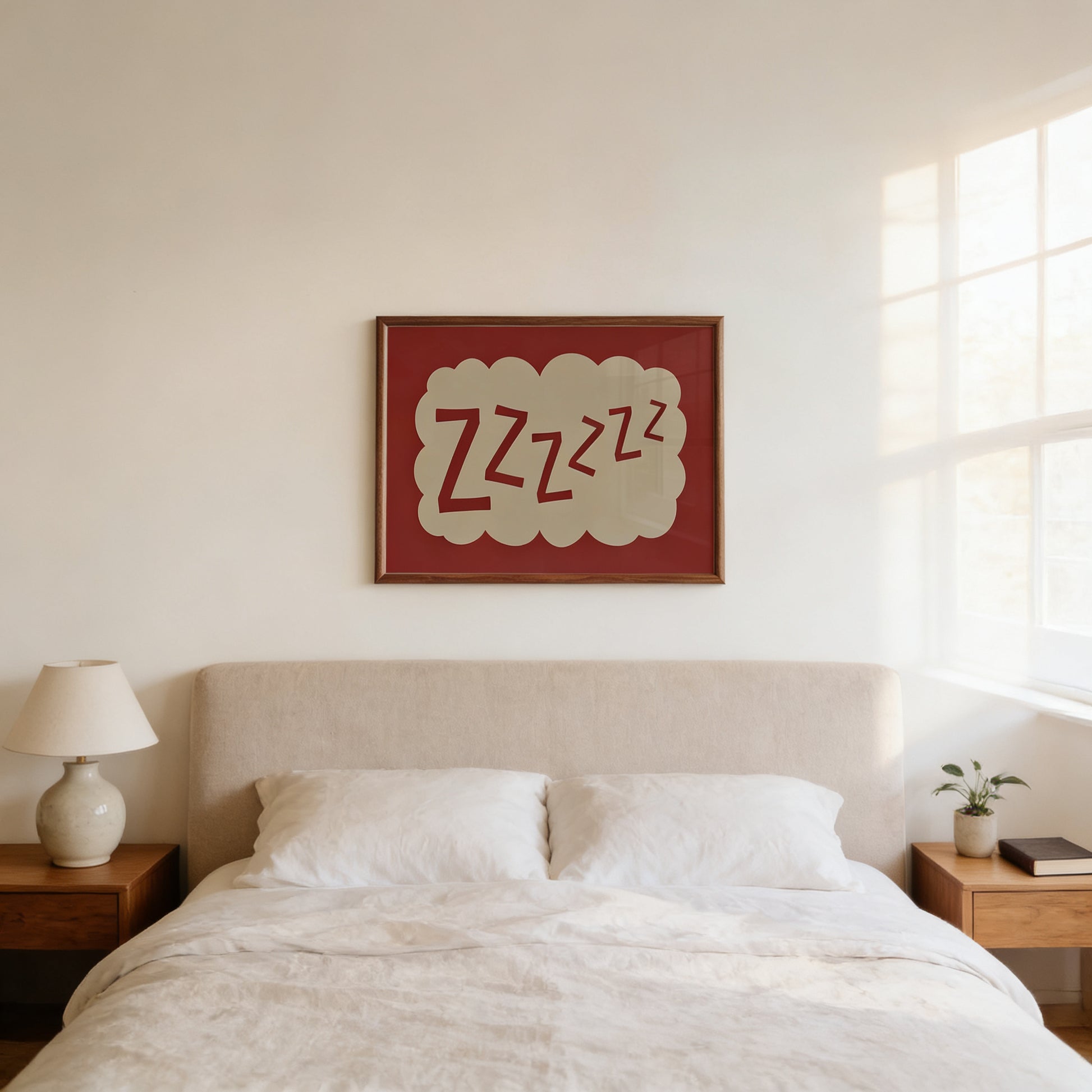 a bedroom with a bed, a nightstand, and a lamp. Above the bed, there is a framed picture with the text "zzzzzz" written on it.