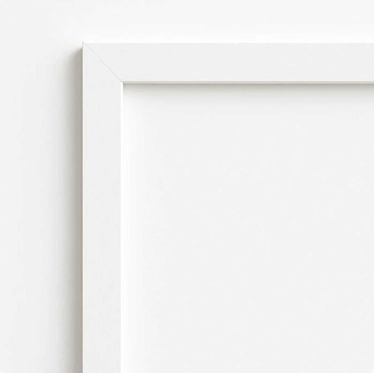 The image is a plain white wall with a white frame.